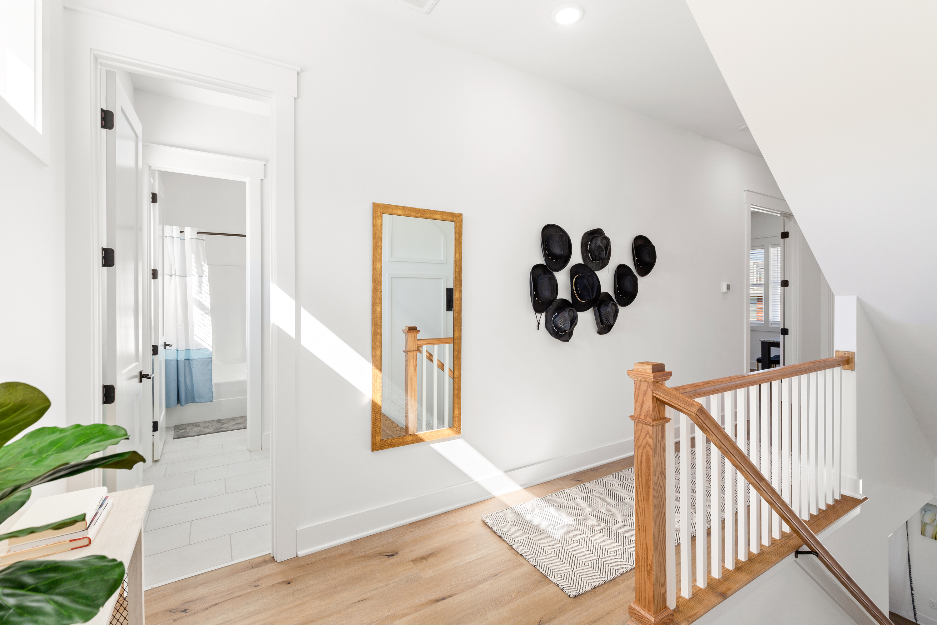 Bright hallway with decorative wall art and wooden railing